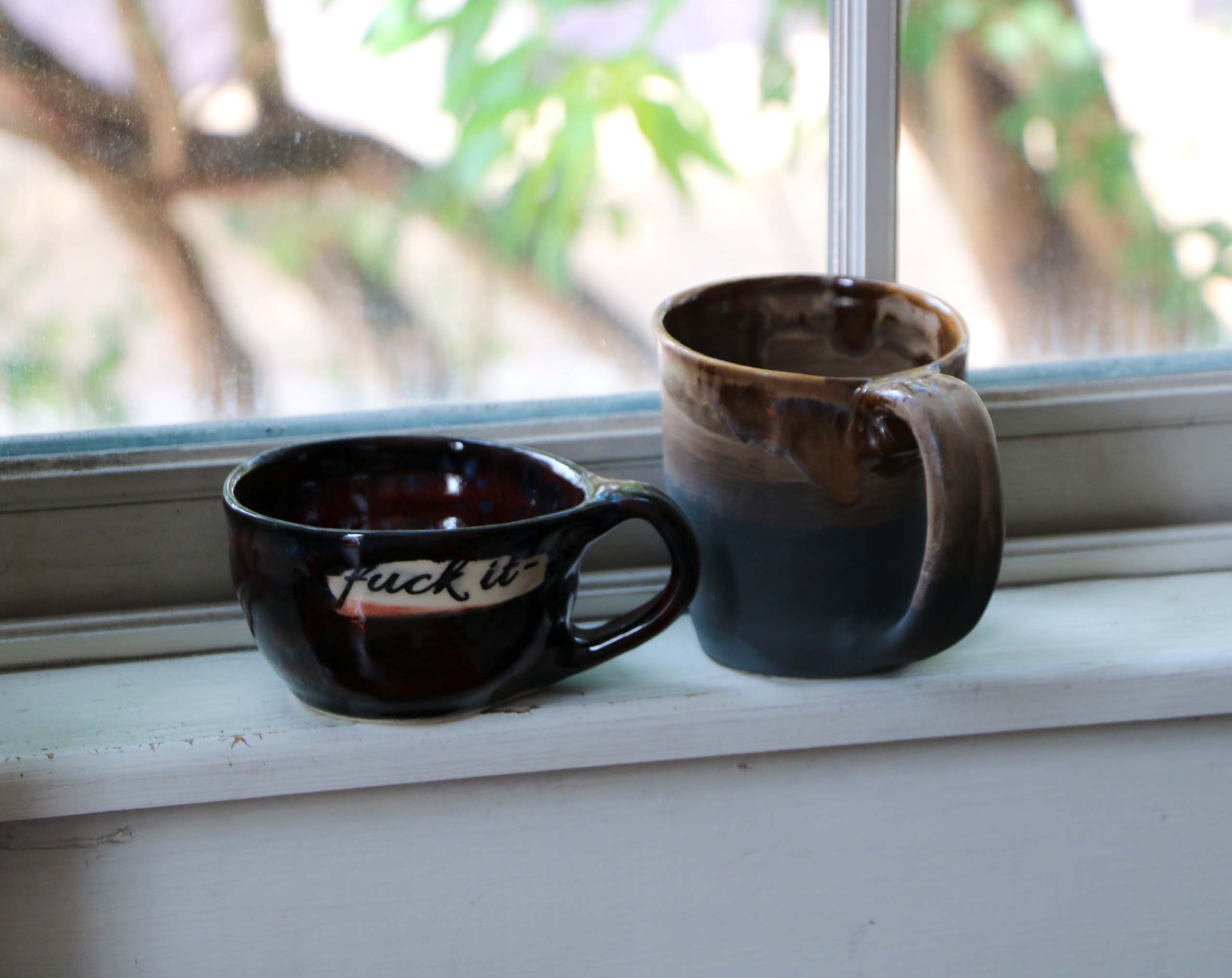 Two Mugs (e.g., small black mug & large brown mug)